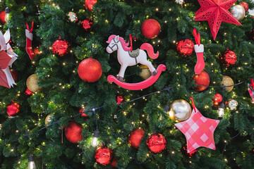 Close-up of Christmas Tree Decorated with Ornaments, Lights, and Rocking Horse Toy