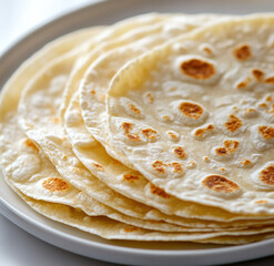 Soft Homemade Flour Tortillas Stacked On White Plate
