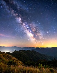 Naklejka premium Majestic Milky Way over rolling hills at night, a breathtaking celestial display.