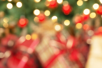 Defocused holiday background of Christmas gifts under the tree, close-up