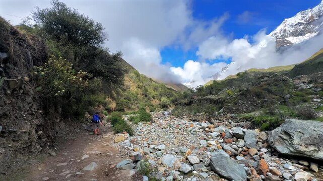 Mount Humantay Peruvian Andes snow capped glacier mountain Salcantay Inca trail trek hiker Peru low fog clouds blue sky rainy dry season Laguna Humantay Soray Anta Cusco region nature landscape pan