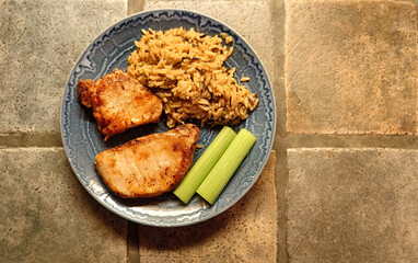 air fried boneless pork chops and wild rice on a blue plate