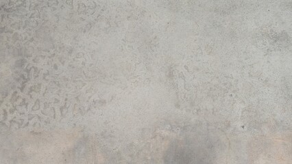 Gray concrete sidewalk with stains and uneven color. Roadside walkway. Texture and background image.