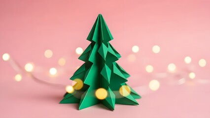 Green origami christmas tree with soft bokeh lights on pink background