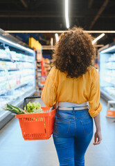 Woman shopping for healthy food in supermarket aisle
