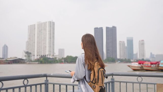 Asian young beautiful woman backpacker exploring the city outdoors. 