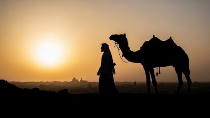 Man and camel silhouette walking in desert at sunset, creating a travel and adventure concept. Arabian desert scenery for a tranquil travel experience.