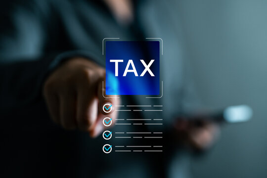 Hand touching virtual tax button with digital checklist. Concept of online tax filing, digital finance, accounting system, fintech solutions, tax preparation and electronic compliance tools.