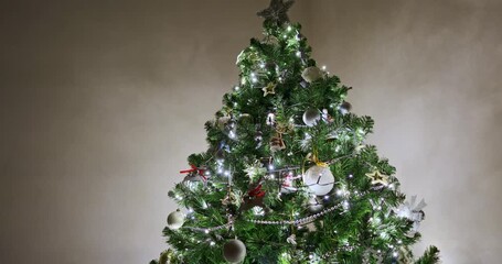 Decorated Christmas tree with silver baubles, wooden reindeer ornaments with red ribbons, ballerina and mouse toys, glowing fairy lights and bead garlands. Christmas tree decorations - Powered by Adobe