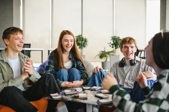Happy friends playing board game at home