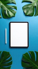 Tablet on blue with tropical leaves