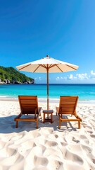 Beach chairs and umbrella on white sand