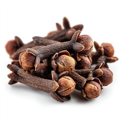 Close-up of dried cloves spice with dark brown color and textured surface, arranged in a small pile on a white background.