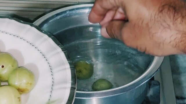 blanching fresh indian gooseberries for traditional cooking and preservation preparation
