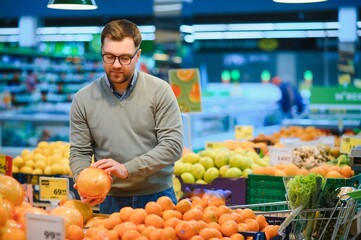 Handsome man shopping in a supermarket