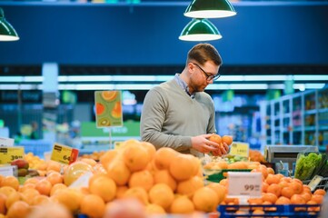 Man buying vegetables and fruit in grocery store, zero waste concept