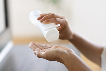 Close-up of Woman's hands Pouring Lotion into Palm