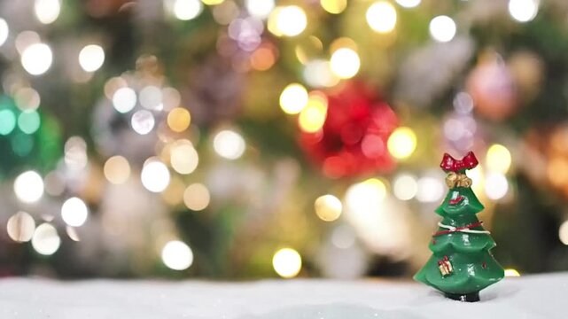Close-up of tiny pine trees with christmas light background