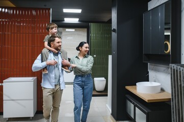 Family exploring ceramic tile and plumbing store
