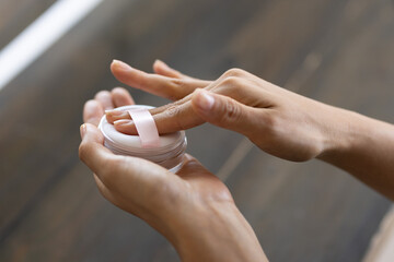 Close-up of Woman’s Hands Using Powder Puff