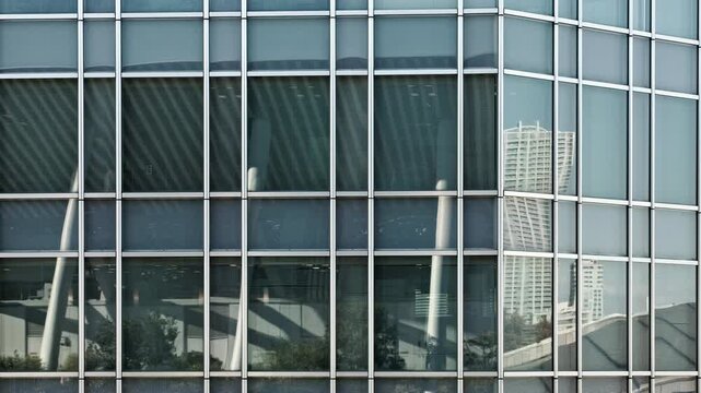 Tokyo Scene : Grid Pattern on the Wall of a Skyscraper Covered Entirely in Glass and the City Reflecting  |  Tokyo, Japan