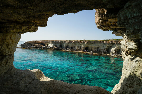 Famous window in Sea Caves of Ayia Napa, beautiful rock formation near Cape Greco, popular tourist and cliff jumping destination, Cyprus