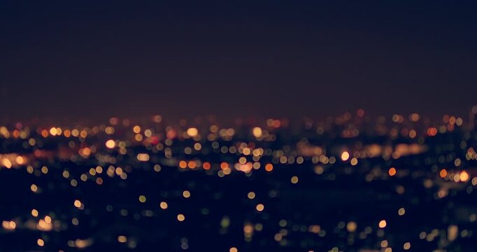 A stunning aerial view of a city illuminated by twinkling lights at night.