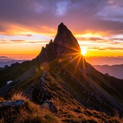 Fototapeta premium Mountain silhouette standing tall against a dramatic sunset sky.