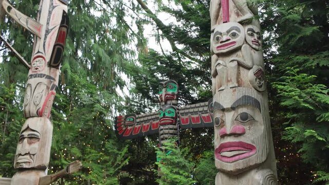 Gimbal close-up panning shot of First Nation totem poles at Capilano Suspension Bridge Park in North Vancouver, British Columbia, Canada. 4K at 30 FPS