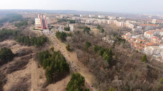 Aerial footage of the Pleven Panorama on Third of March 2019. Visitors gather in Skobelev Park, paying tribute and carrying a 740-meter Bulgarian flag, BG, EU, 03 March 2019