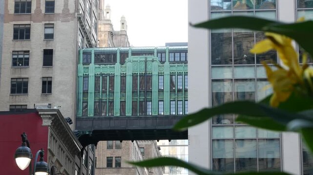 New York City Gimbels bridge, Manhattan Midtown, United States of America. Skybridge on Broadway, Herald Square, USA. Gimbels traverse on 6 avenue. Historic elevated walkway 1925, copper green patina.