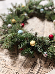 Making rustic Christmas wreath. Moody Christmas image, holiday preparations. High quality photo