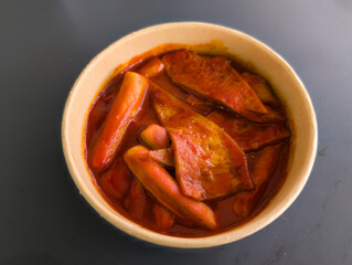 Delicious Toppoki with Spicy Red Sauce in Classic White Bowl