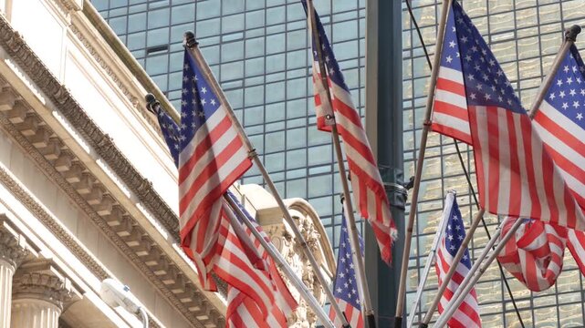 American flags near Grand Central Terminal on 42 street, New York City, Manhattan Midtown. Railway building architecture in United States. Public railroad transport junction. Old station exterior.