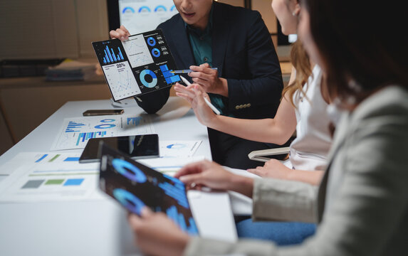 Business team analyzing data charts during corporate meeting