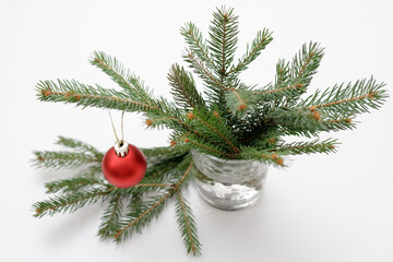 New Year's composition with Christmas tree branches, and red balls for the Christmas tree