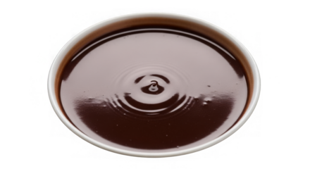 A white bowl of dark liquid with ripples