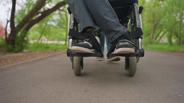 Caster Wheel Rotates During Movement, Low Angle Shot Highlights Turning Caster Wheel On Park Path, Wheelchair Caster Wheel Smoothly Rotates As It Moves Along Park Trail In Low Angle Perspective
