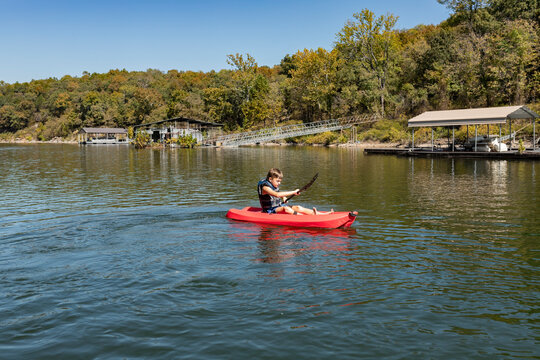 Boy kayaking on lake on a sunny day