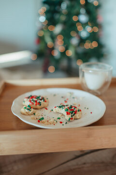 Christmas cookies eaten by Santa with milk on wooden tray