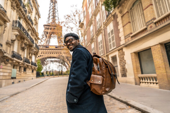Happy black man traveling in paris viewing eiffel tower