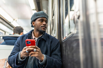 Young man commuting on subway looking out window