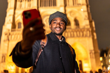 Young black man taking selfie in paris at night