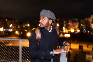 Young man traveling through paris city at night