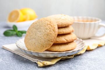 Tasty lemon cookies on grey table, closeup