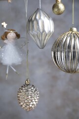 Obraz premium Beautiful Christmas decor hanging near light grey wall, closeup