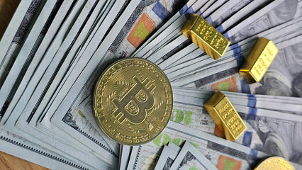 A collection of money, bitcoin, and gold bars on a wooden table showing various forms of currency and investment concept