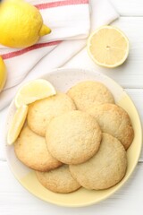 Tasty lemon cookies and fruits on white wooden table, flat lay