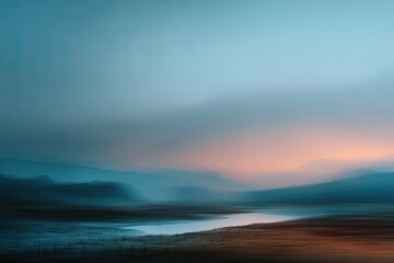 Obraz premium Blurred landscape view features mountain range, river, and gradient sky during dusk