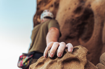 Climber Gripping Rock Hold with Chalked Hand